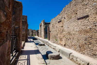 The streets of pompeii made of large blocks of black volcanic rocks