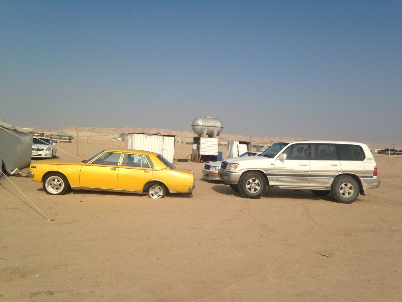 transportation, mode of transport, land vehicle, car, stationary, clear sky, copy space, street, parked, parking, travel, yellow, road, day, outdoors, blue, vehicle, on the move, no people, sunlight