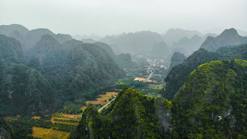 Scenic view of limestone mountains against sky at cat ba island, vietnam.