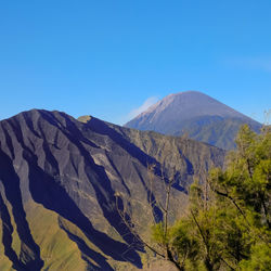 Scenic view of mountains against clear blue sky