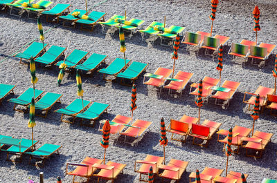 High angle view of empty sunbeds in row