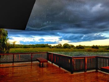 View of empty bridge against cloudy sky