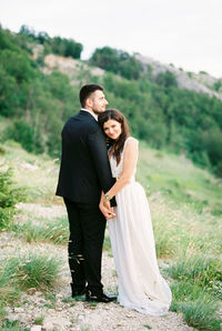 Portrait of smiling couple standing on field