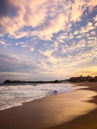 Scenic view of beach against sky during sunset