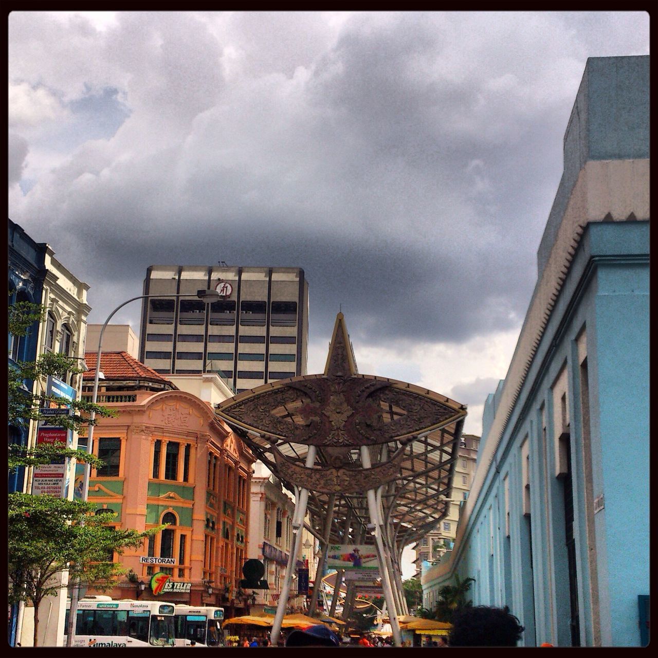 architecture, building exterior, built structure, transfer print, sky, cloud - sky, cloudy, auto post production filter, city, building, cloud, car, residential building, transportation, low angle view, residential structure, land vehicle, overcast, incidental people, day