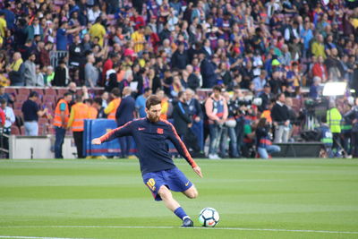 Group of people playing soccer on field