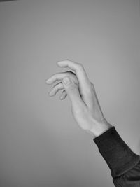 Close-up of person hand against gray background