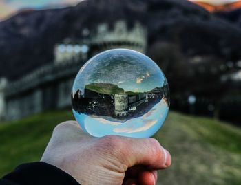 Close-up of person hand holding crystal ball