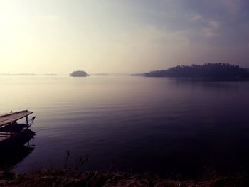 Scenic view of lake against sky at sunset