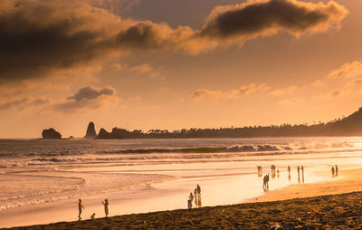 Scenic view of beach against sky during sunset