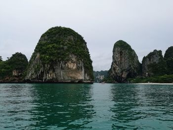 Scenic view of rock formation by sea against sky