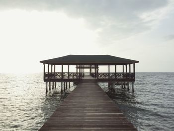 Pier over sea against sky