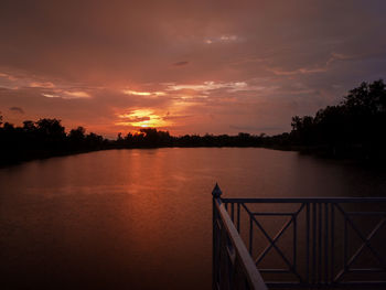 Scenic view of lake against orange sky