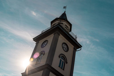 Low angle view of clock tower and building against sky