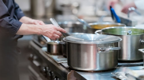 Male chief in the restaurant preparing dinner.