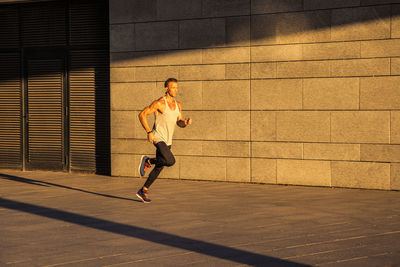 Full length of man running on wall