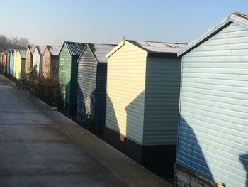 Sunlight falling on beach houses against clear sky