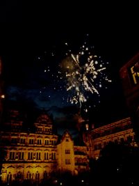 Low angle view of firework display at night