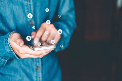 Close-up of man holding mobile phone