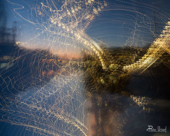 Abstract image of light trails against sky at night