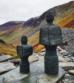 Stack of rocks on mountain against sky