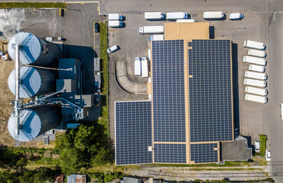 Directly above shot of solar panels on building roofs during sunny day