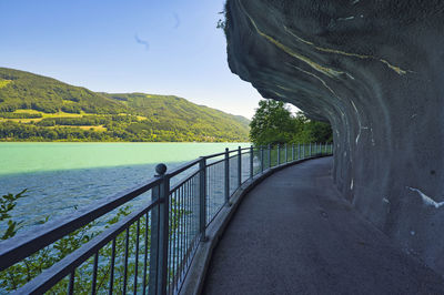 Scenic view of river by mountains against sky