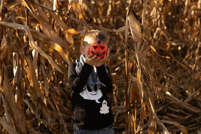 Young boy standing amidst plants