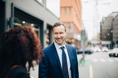 Portrait of a smiling young man in city