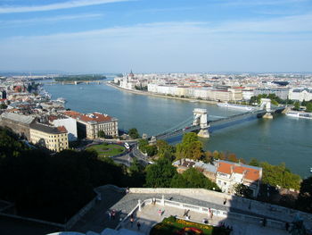 High angle view of river amidst buildings in city against sky