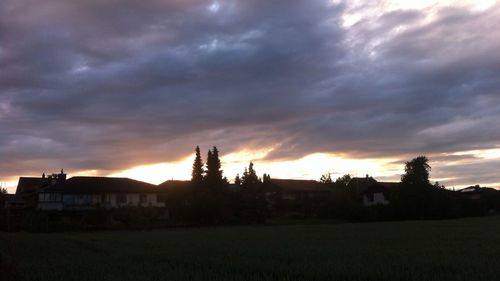Scenic view of field against cloudy sky