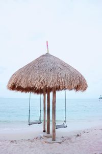 Lifeguard hut on beach against clear sky