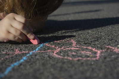Close-up of child chalk drawing on road