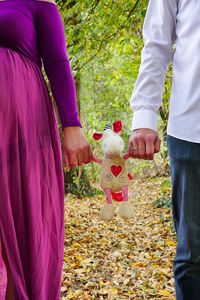 Midsection of couple holding toy