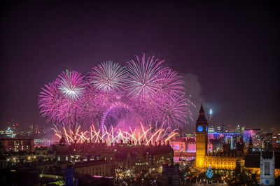 High angle view of firework display at night