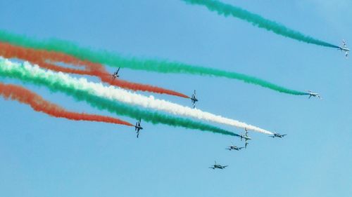 Low angle view of airshow against clear sky