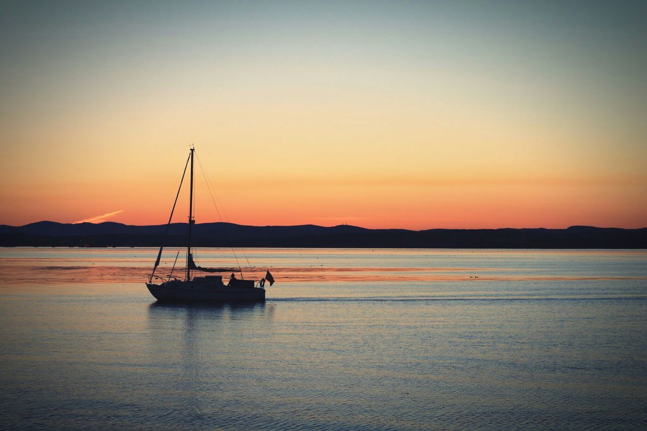 sunset, water, nautical vessel, transportation, boat, silhouette, mode of transport, orange color, tranquil scene, scenics, tranquility, beauty in nature, waterfront, reflection, sea, nature, clear sky, idyllic, moored, copy space