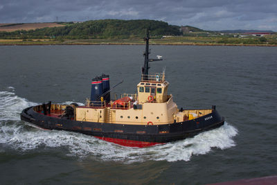 Ship sailing on sea against sky