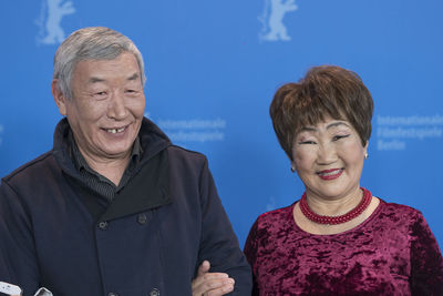 Portrait of a smiling man and woman against blue sky