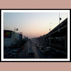 Traffic on road at sunset