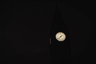 Close-up of clock against sky