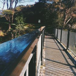 Swimming pool by trees against sky