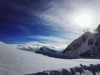 Scenic view of snow covered mountains against sky