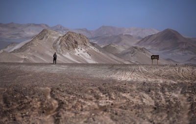 Mid distance view of man standing on landscape