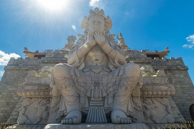 Low angle view of statue against sky