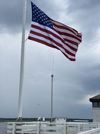 Low angle view of flags against sky