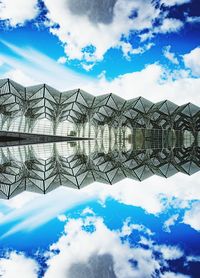 Low angle view of buildings against cloudy sky