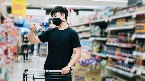 Full length of man standing at store