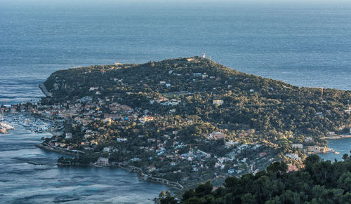 High angle view of townscape by sea against sky