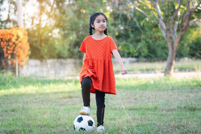 Full length of boy playing with ball in park